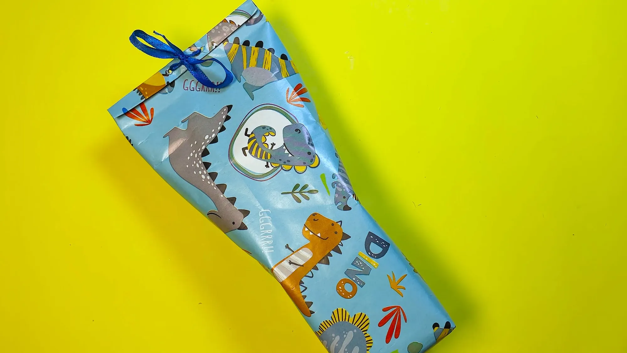 diy-dinosaurier-verpackung-aus-papier-schritt-3.jpg Dinosaurier-Verpackung aus Papier Schritt 3: Fertiges Geschenk mit Schleife