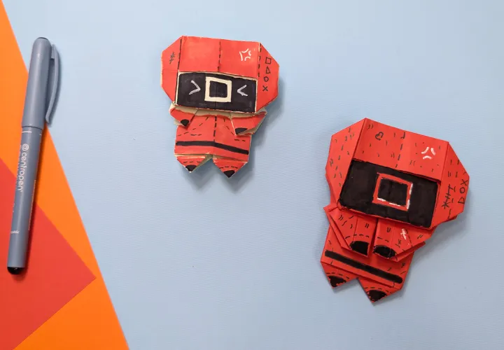 Penjaga origami dari Squid Game: Panduan dengan Video, Foto, dan Deskripsi