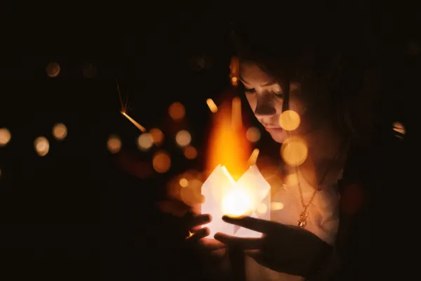 Woman with candle. The image was enhanced with effective bokehs using textures.