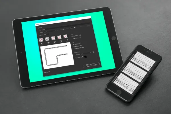 Планшет та смартфон, що показують кисті Adobe Illustrator