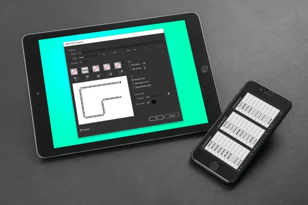 Tablet i smartfon prezentujące pędzle Adobe Illustrator.